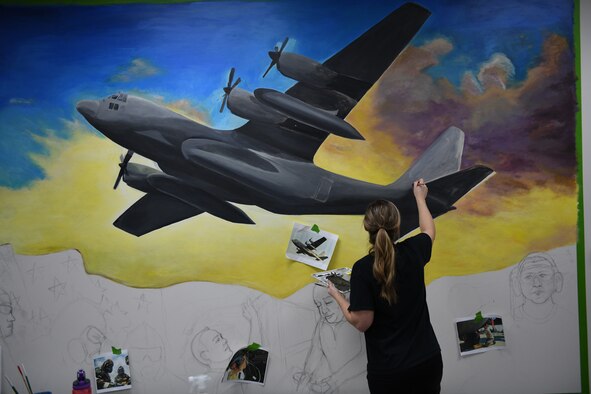 Tech. Sgt. Maralene Scarpino, an aircraft maintenance specialist assigned to the 910th Maintenance Squadron, paints a mural in the 910th Maintenance Group's heritage room at Youngstown Reserve Station, Dec. 17, 2018.