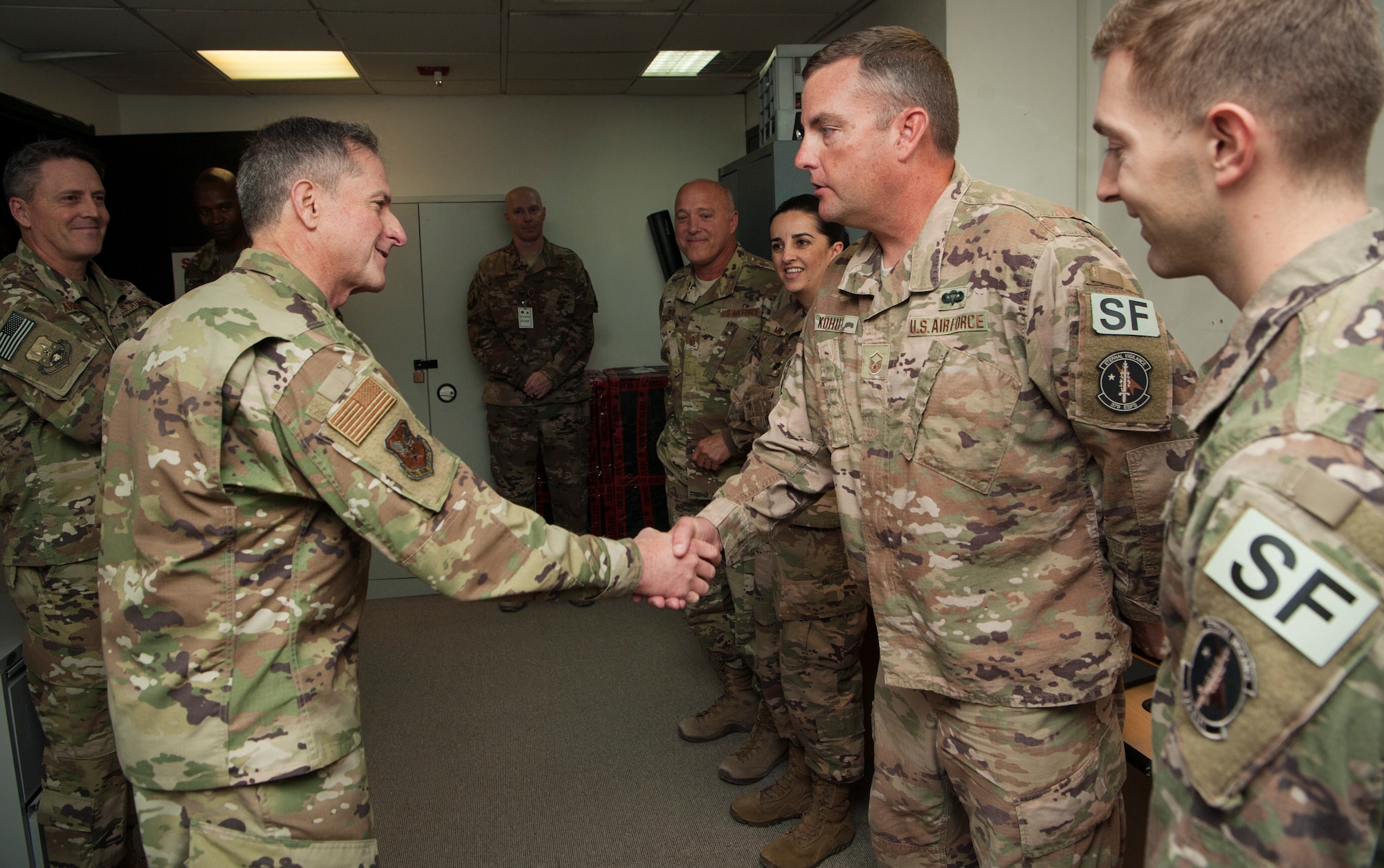 U.S. Air Force Chief of Staff Gen. David L. Goldfein coins Master Sgt. Christopher Kohut, 379th Expeditionary Security Forces Squadron, for exceptional performance prior to a base-wide “all call” at Al Udeid Air Base, Qatar, Dec. 19, 2018. Outstanding Airmen were selected to meet with Goldfein and were recognized for their contributing to the 379th Air Expeditionary Wing’s mission. During the all call, Goldfein and Chief Master Sgt. of the Air Force Kaleth O. Wright emphasized their gratitude for the safety and security provided by Airmen serving at Al Udeid while also encouraging Airmen to take ownership of their Air Force. (U.S. Air Force photo by Tech. Sgt. Christopher Hubenthal)