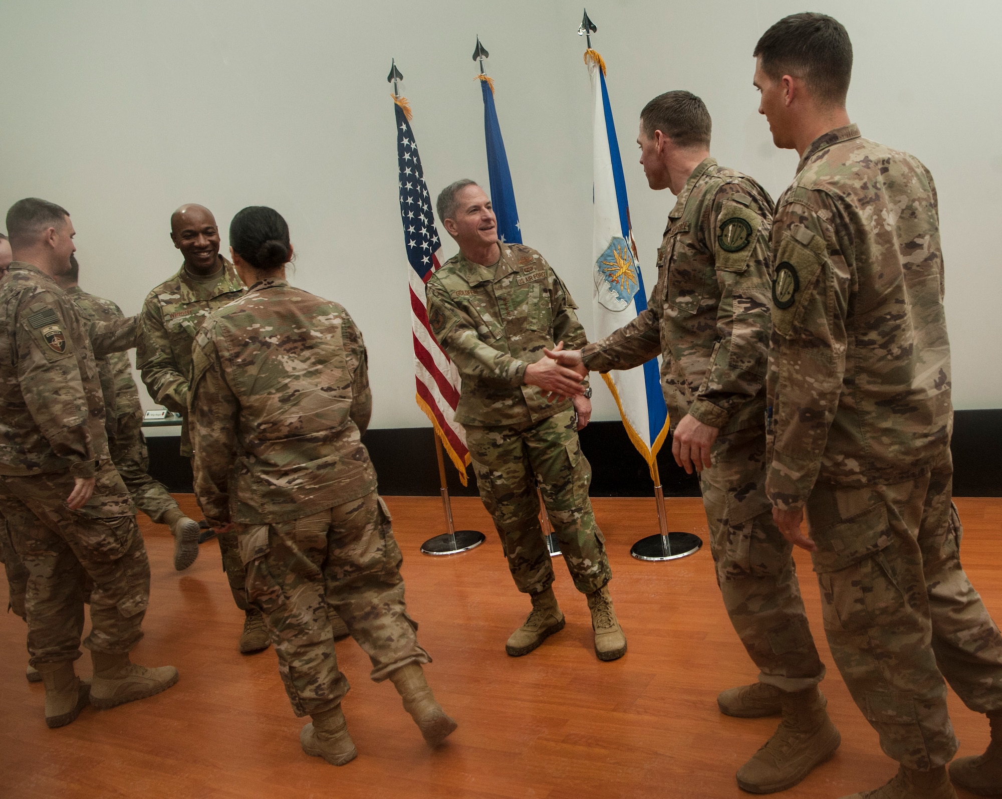 U.S. Air Force Chief of Staff Gen. David L. Goldfein (center) and Chief Master Sgt. of the Air Force Kaleth O. Wright (left of center) meet and talk with Airmen after a base-wide “all call” at Al Udeid Air Base, Qatar, Dec. 19, 2018. Answering a question from the audience, Goldfein and Wright voiced support for changes that would allow Airmen to move more seamlessly between reserve, guard, and active-duty status. (U.S. Air Force photo by Tech. Sgt. Christopher Hubenthal)