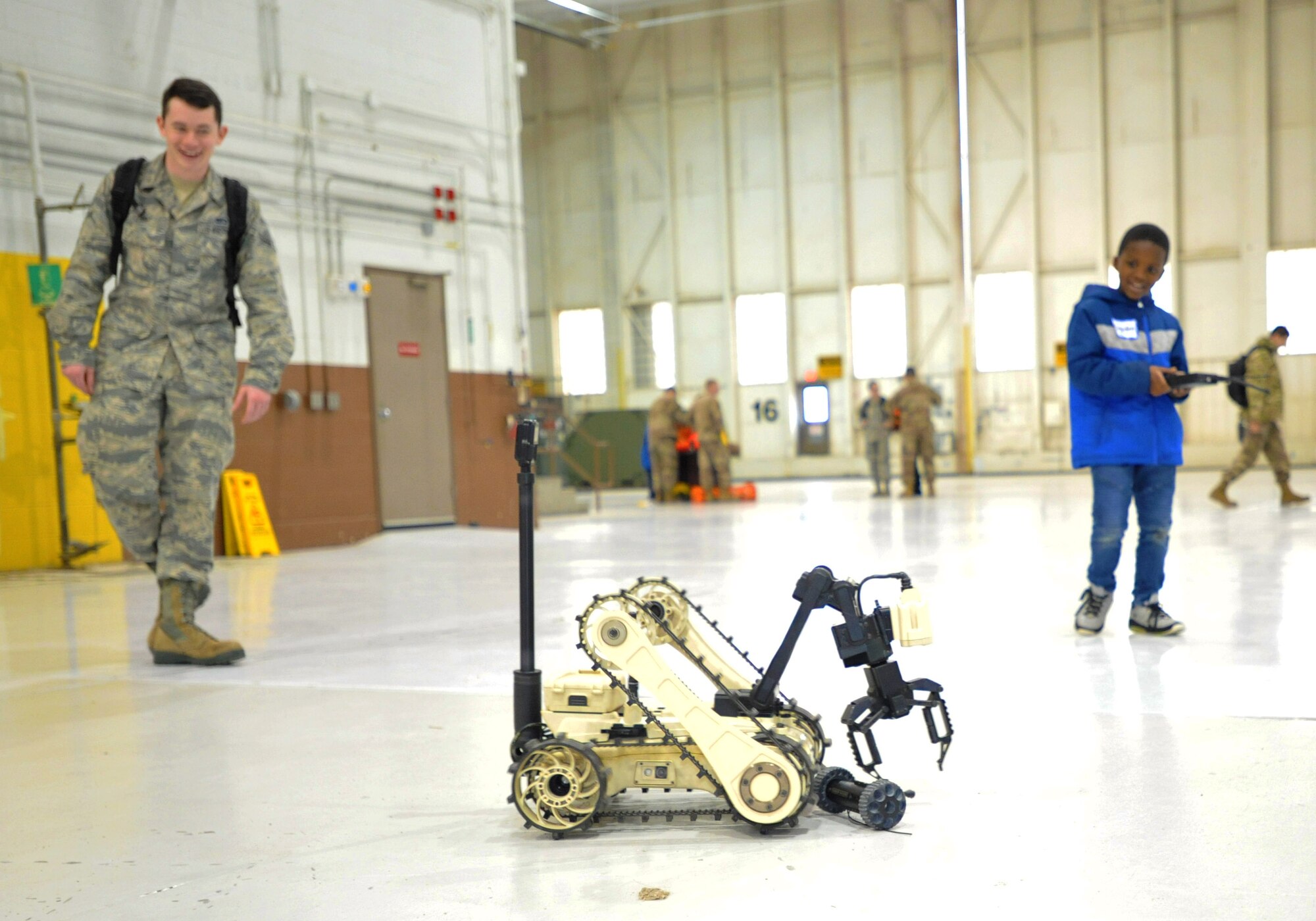 A child from Big Brothers Big Sisters drives a remote controlled vehicle from the Explosive Ordinance Disposal flight Dec. 19, 2018, at McConnell Air Force Base, Kansas. The children spent time in a hangar learning about military working dogs, explosive ordinance disposal, aircrew flight equipment and the KC-135 Stratotanker. (U.S. Air Force photo by Staff Sgt. David Bernal Del Agua)