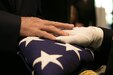 FORT KNOX, Ky. -  A 1st Theater Sustainment Command Soldier presents a folded American flag to a family member of a deceased service member, Nov. 5.