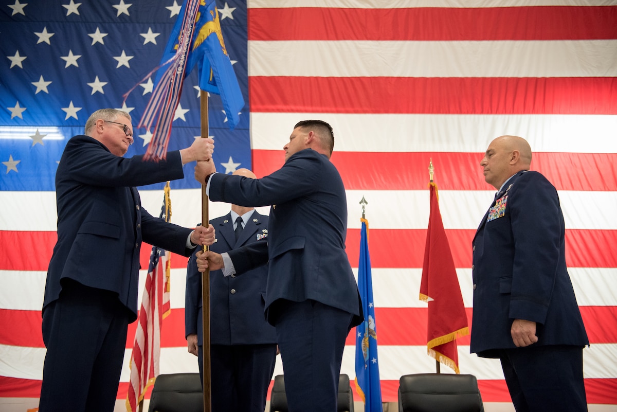 Col. Ashley Groves (center), assumes command of the 123rd Maintenance Group as he accepts the unit’s guidon from Col. David Mounkes (left), commander of the 123rd Airlift Wing, during a ceremony at the Kentucky Air National Guard Base in Louisville, Ky., on Dec. 1, 2018. Groves is replacing Col. Ken Dale, who is retiring after more than 38 years of service to the Kentucky Air National Guard. (U.S. Air National Guard photo by Staff Sgt. Joshua Horton)