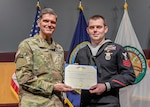U.S. Army Gen. Joseph Votel, U.S. Central Command commander (left), presents U.S. Navy Petty Officer 1st Class Brian Mazi, USCENTCOM intelligence specialist, with the Navy-Marine Corps Medal on Dec. 18. Mazi was recognized for his heroism during the October 2017 tragedy that left 58 dead and more than 500 wounded at a country music festival in Las Vegas. The award falls between the Distinguished Flying Cross and the Bronze Star in order of merit.