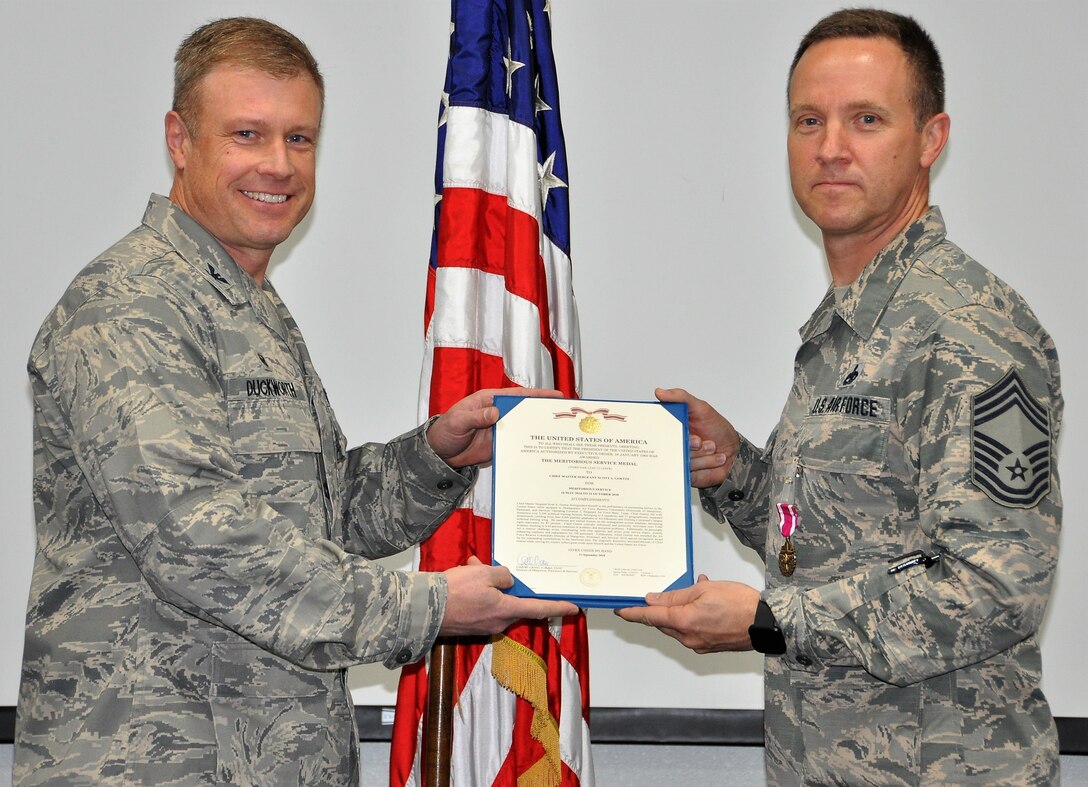 Chief Master Sgt. Scott Goetze, 340th FTG superintendent, accepts the Meritorious Service Medal from 340th Flying Training Group Commander Col. Allen Duckworth during the Dec. 13-14 mandatory unit training assembly (or MUTA) at Joint Base San Antonio, Texas. The chief earned the MSM while assigned to the Air Force Reserve Command Directorate of Manpower, Personnel and Services Operating Location at Sheppard Air Force Base, Texas. (U.S. Air Force photo by Tech. Sgt. Brianne Blackstock)