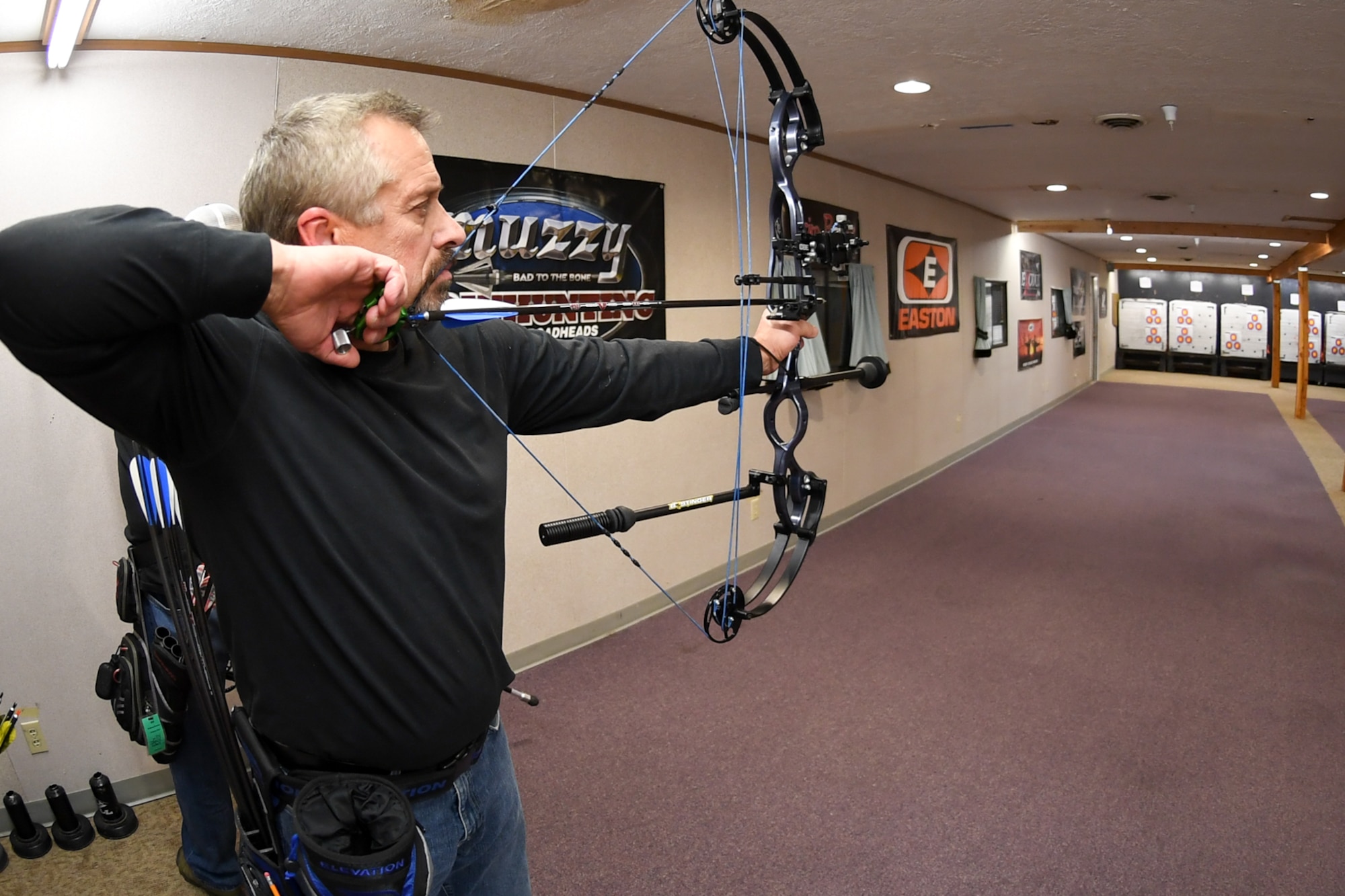 Brian Wade aims his compound bow at a three-spot target during a Hill Archery Club league night Dec. 13, 2018, at Hill Air Force Base, Utah. Besides access to the clubhouse and ranges 24/7, Hill club members are also invited to participate in several archery events throughout the year.  (U.S. Air Force photo by Cynthia Griggs)