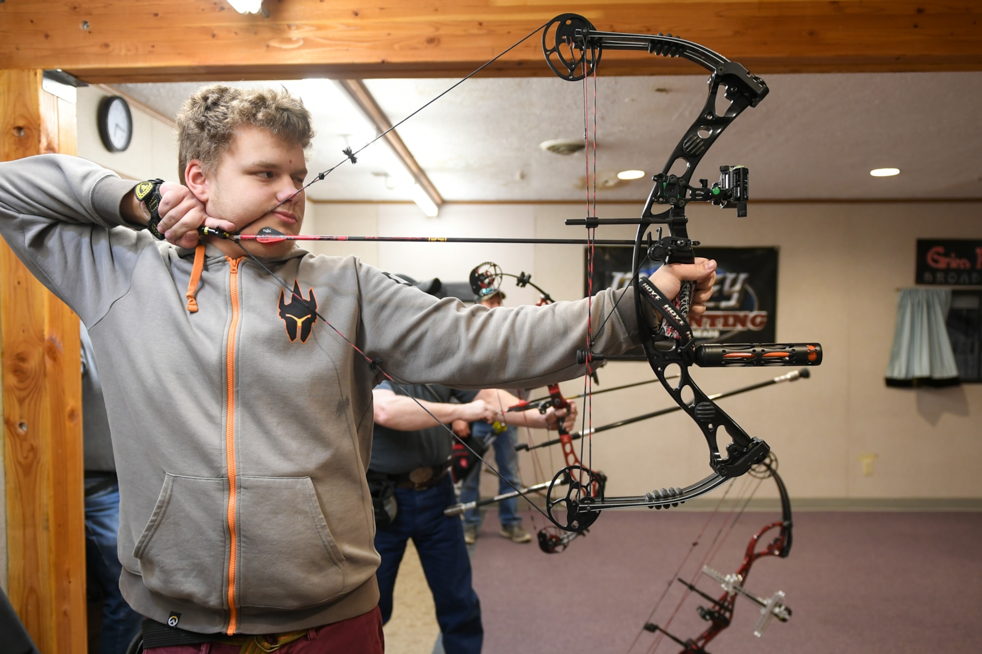 Kevin Tracy aims his compound bow at a three-spot target during a Hill Archery Club league night Dec. 13, 2018, at Hill Air Force Base, Utah. Besides access to the clubhouse and ranges 24/7, Hill club members are also invited to participate in several archery events throughout the year. (U.S. Air Force photo by Cynthia Griggs)