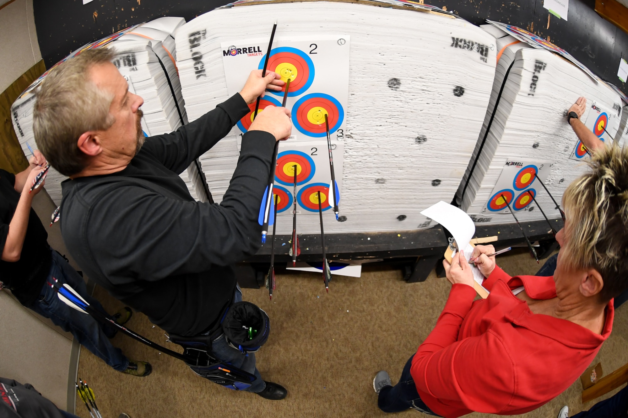 Hill Archery Club members Brian Wade and Shellay Williams tally up their points during a club league night Dec. 13, 2018, at Hill Air Force Base, Utah. The 20-yard indoor range at Hill’s archery clubhouse houses five lanes for shooting. There are also four different outdoor ranges. (U.S. Air Force photo by Cynthia Griggs)