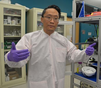 Dr. Tony Yuan, Naval Medical Research Unit San Antonio senior scientist and biomedical engineer at Joint Base San Antonio-Fort Sam Houston, explains how the electrospinner system operates. The fully automated electrospinner, constructed in 2012, uses high voltage electricity as a force to produce a nanofibrous scaffold from biomaterials for a new type of wound dressing containing natural fibers that can be used to deliver biomolecules and drugs to heal the wounds of service members injured in combat. Advancements in electrospinning and the development of nanofibrous wound dressings made by NAMRU-SA researchers could speed up the healing process for troops wounded on the battlefield, reducing complications and scar formations and improving patient outcomes.