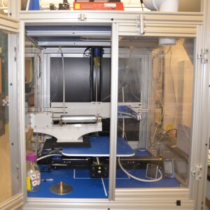 The first-generation electrospinner is displayed at the Naval Medical Research Unit San Antonio at Joint Base San Antonio-Fort Sam Houston. The electrospinner, which was built in 2012, is being used for a research project at NAMRU-SA to produce a new type of wound dressing, a nanofibrous scaffold which contains natural fibers to deliver biomolecules and drugs to heal and treat the wounds of service members injured in combat. The fully automated electrospinner uses high voltage electricity as a force to produce and create the nanofibrous scaffold from biomaterials.