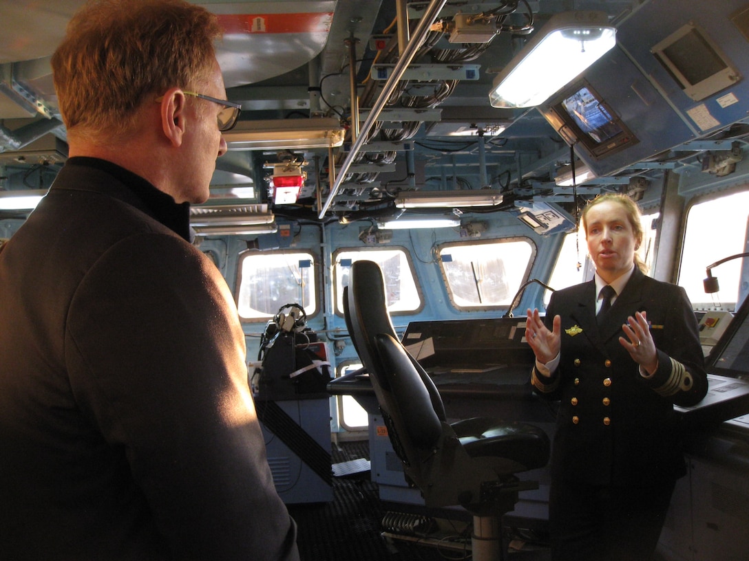 A Norwegian Navy officer speaks to U.S. Navy Undersecretary Thomas B. Modly.