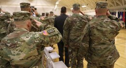 FORT KNOX, Ky. – Soldiers from the 1st Theater Sustainment Command salute the flag while the national anthem is played at the Blue Team redeployment ceremony at the Sadowski Center, Dec. 12. The team deployed to Kuwait in December and spent six-months there, traveling to various countries in the Middle East, in support of their mission. (U.S. Army photo by Mr. Brent Thacker)