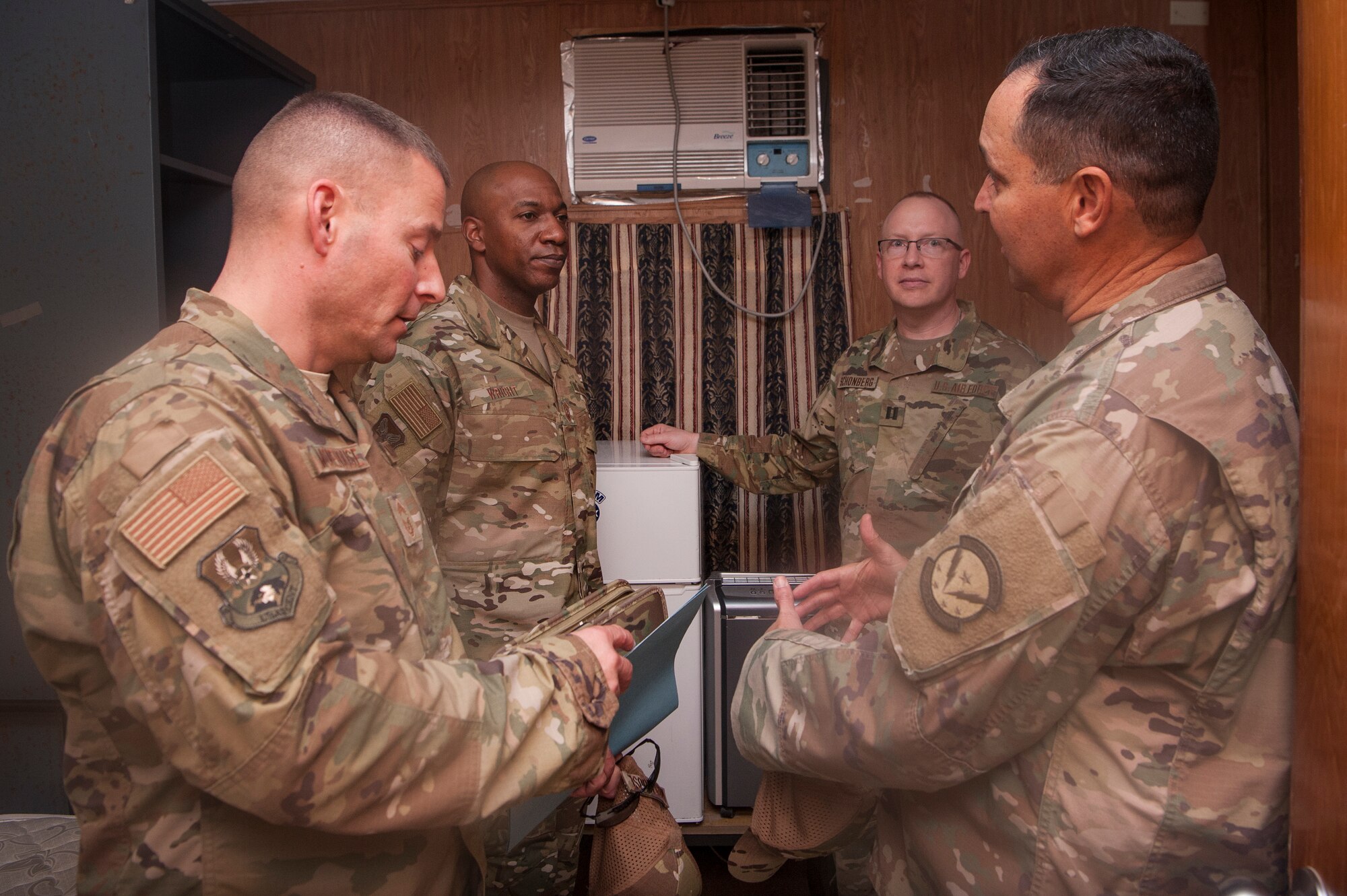 Chief Master Sgt. of the Air Force Kaleth O. Wright (center left) tours a Coalition Compound residential building with base leaders at Al Udeid Air Base, Qatar, Dec. 20, 2018. During the tour, Wright received a first-hand look at the facilities where Airmen live while at Al Udeid. (U.S. Air Force photo by Tech. Sgt. Christopher Hubenthal)