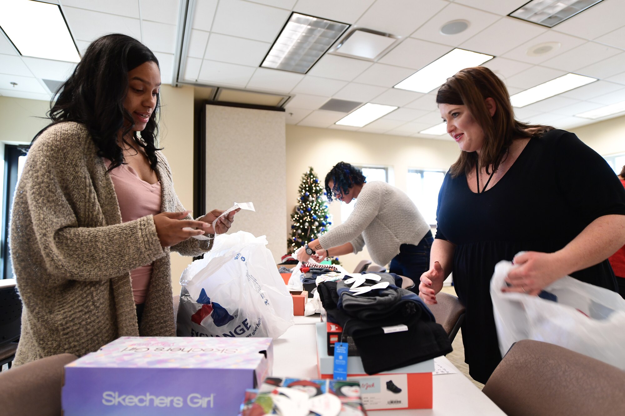 Buckley Spouses Group members ensure donated gifts meet the Angel Tree recipient’s requests as best as possible at Buckley Air Force Base, Colorado, Dec. 19, 2018.