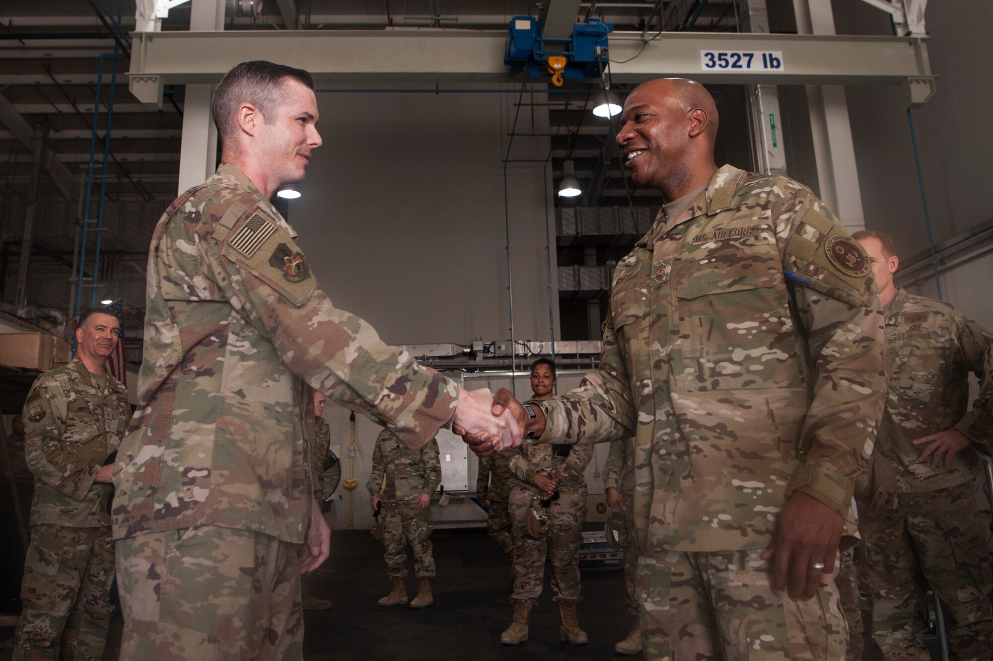 Chief Master Sgt. of the Air Force Kaleth O. Wright recognizes Master Sgt. Steven Liley, 379th Expeditionary Maintenance Squadron crash recovery section chief, for exceptional performance at Al Udeid Air Base, Qatar, Dec. 20, 2018. Wright recognized several individuals while also learning about some of the unique jobs fulfilled by Al Udeid Airmen during his visit to the base. (U.S. Air Force photo by Tech. Sgt. Christopher Hubenthal)