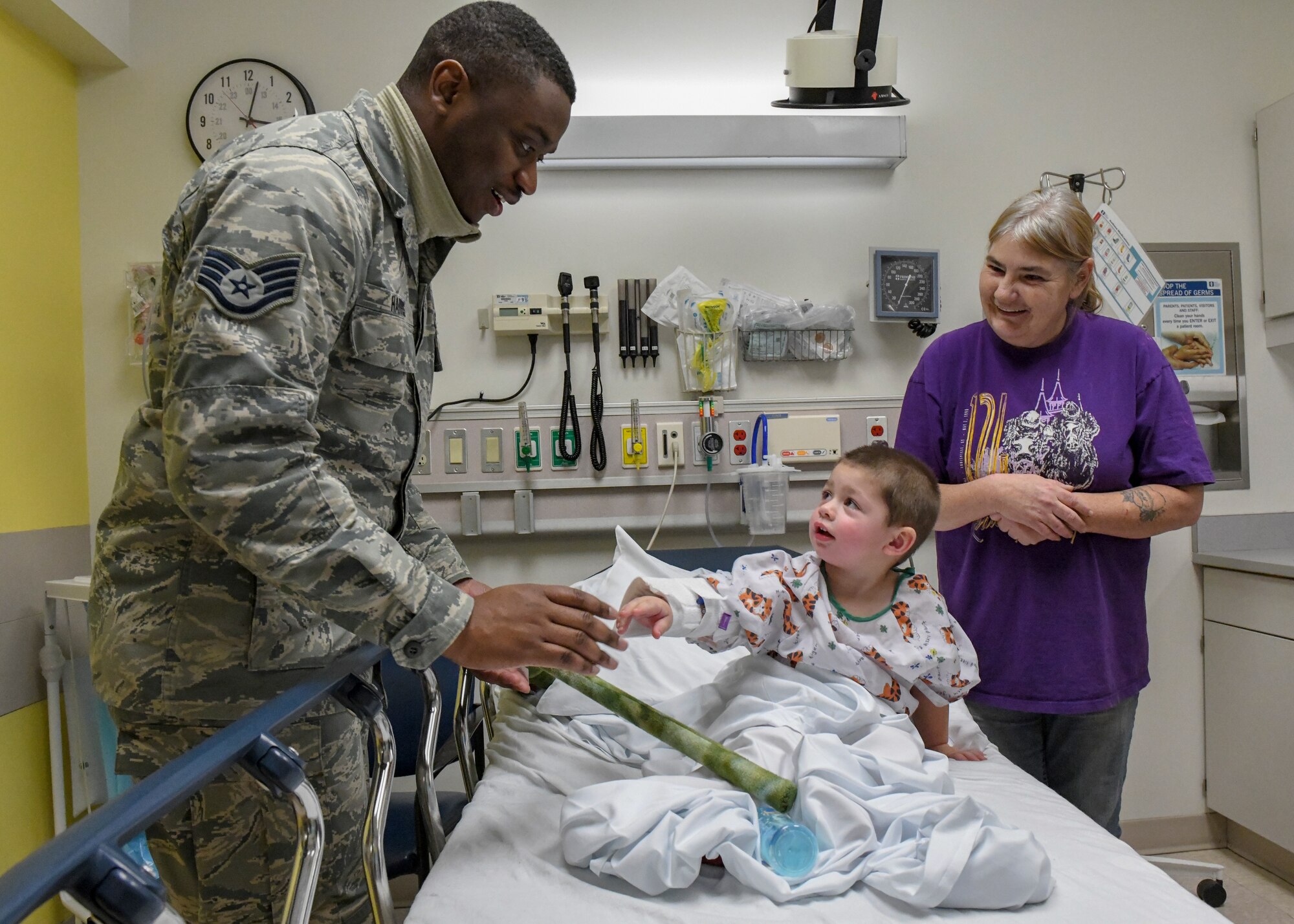 Staff Sgt. James Harris III, a customer support technician assigned to the 910th Force Support Squadron gives a toy to a patient at Akron’s Children’s Hospital in Boardman, Dec. 18, 2018.