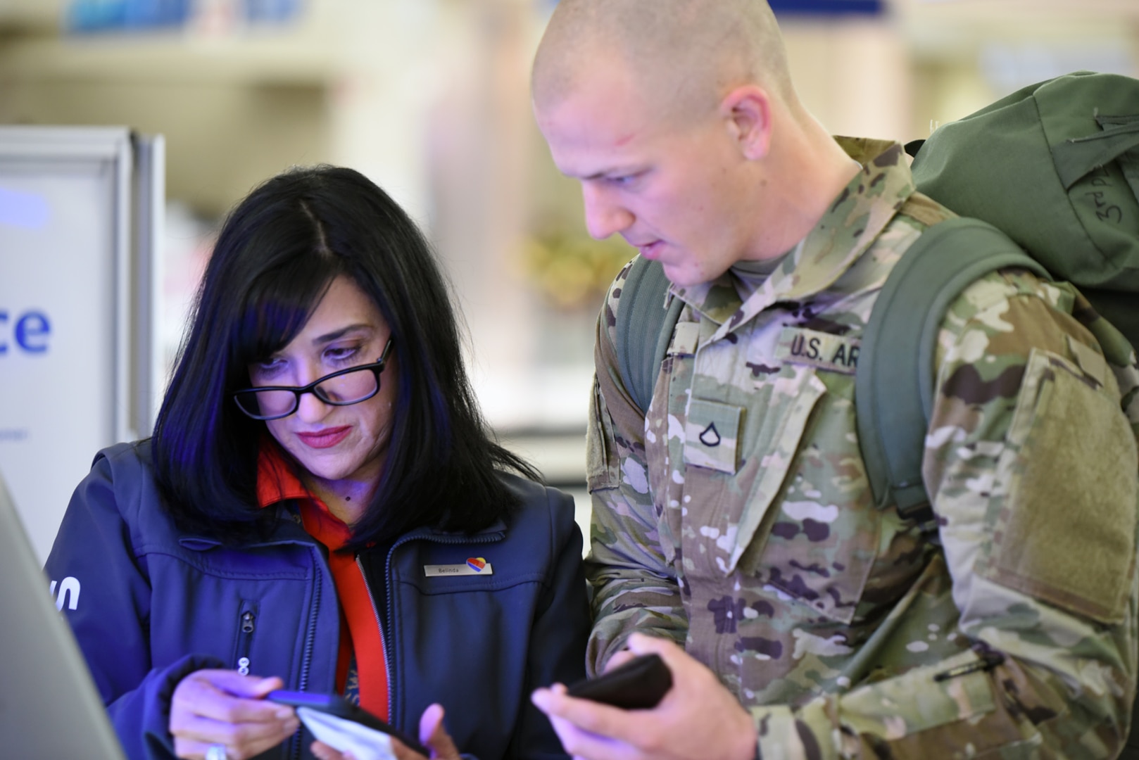 A airline employee assists an Army Soldier to check in for his flight at the San Antonio International Airport Dec. 20.