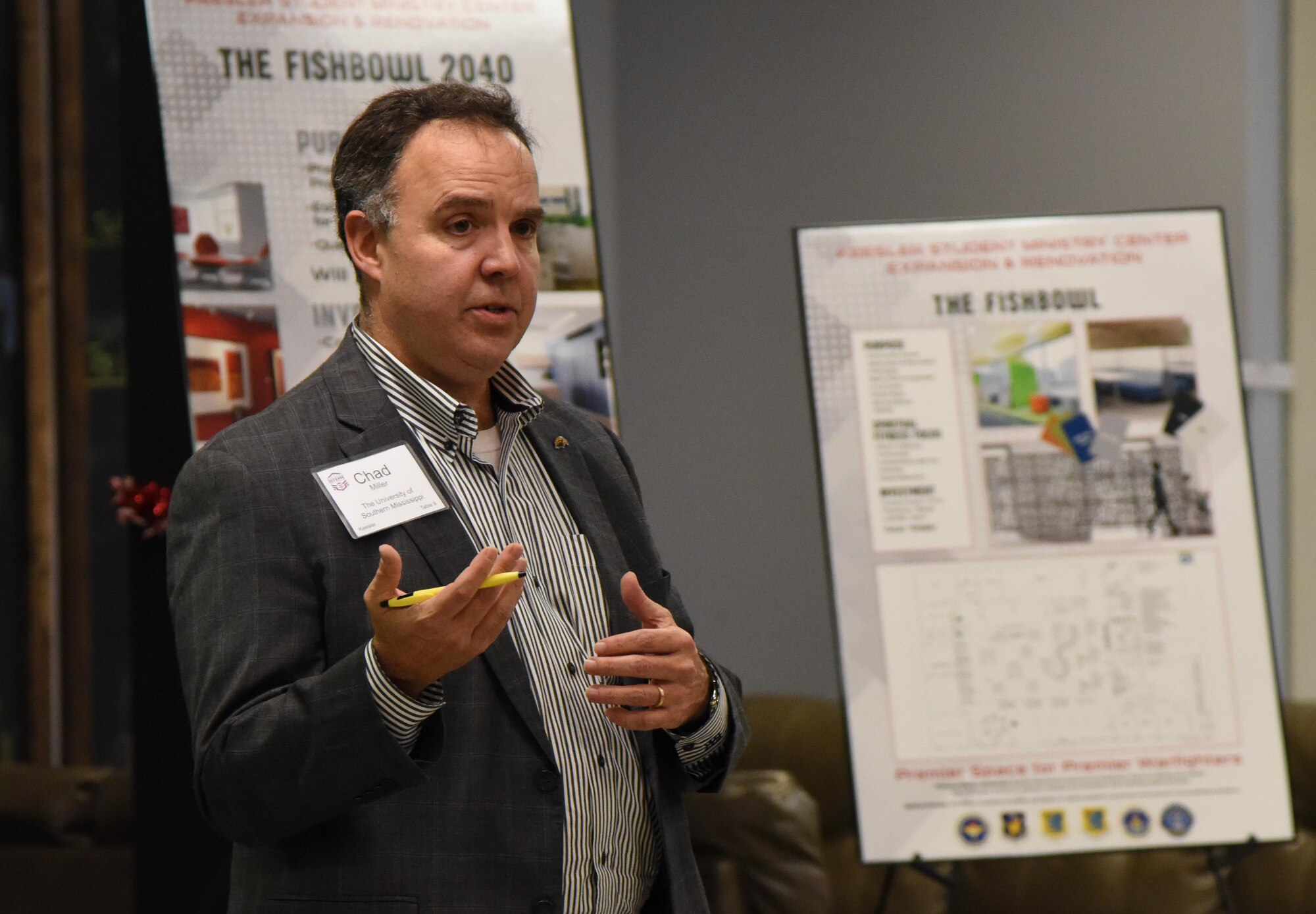 Chad Miller, University of Southern Mississippi professor and economic development program coordinator, speaks to Keesler personnel and members of the Governor's Defense Initiative Task Force during a visit to Keesler Air Force Base, Mississippi, Dec. 13, 2018. Keesler hosted the delegation in order to engage in discussion about making Mississippi a more attractive place for Airmen and their families and to attract more defense industry. (U.S. Air Force photo by Kemberly Groue)