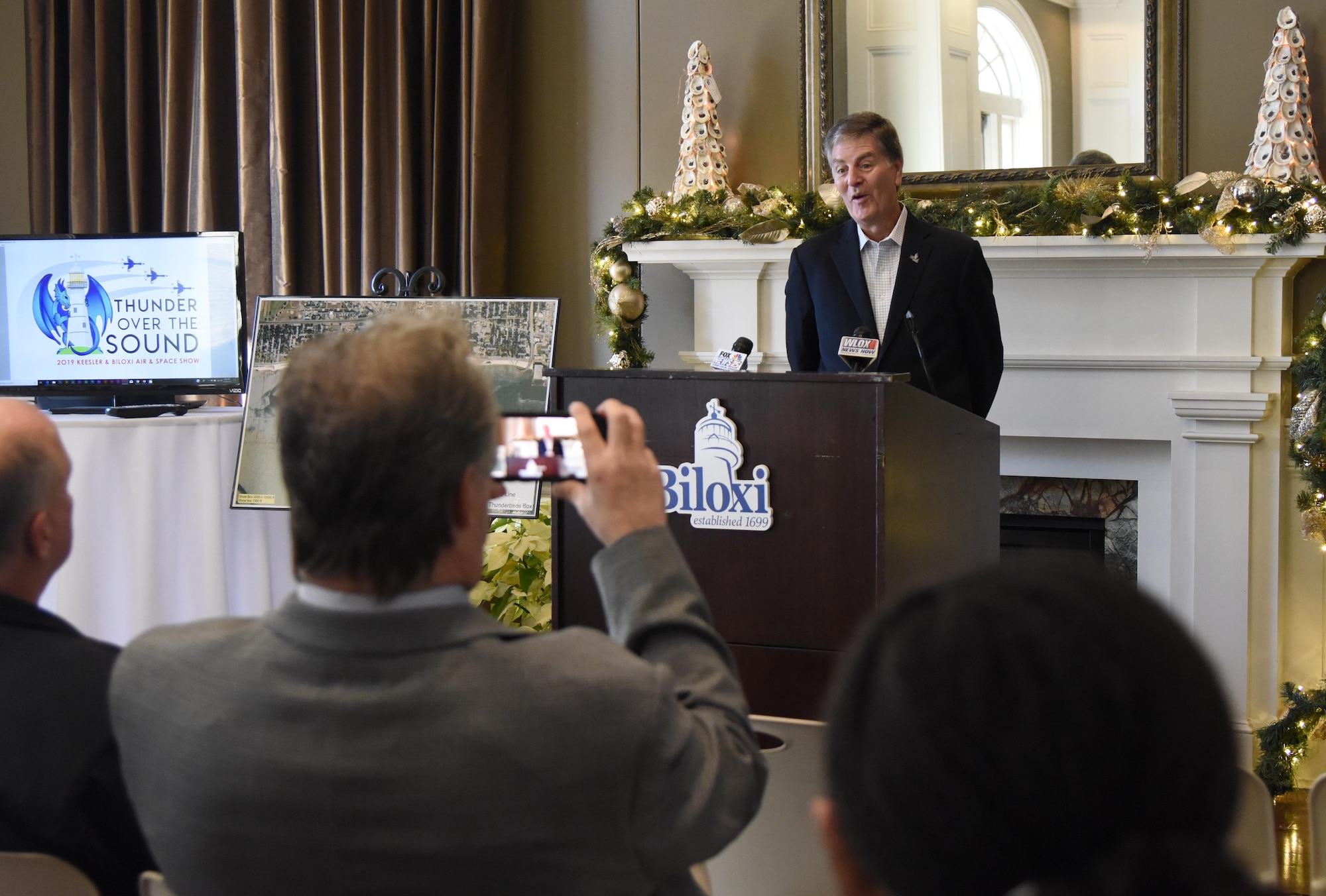 Andrew "Fo Fo" Gilich, Biloxi mayor, delivers remarks during a press conference formally announcing Thunder Over the Sound: The Keesler and Biloxi Air and Space Show at the Biloxi Visitors Center, in Biloxi, Mississippi, Dec. 18, 2018. Gilich was joined by U.S. Air Force Col. Lance Burnett, 81st Training Wing vice commander, and two U.S. Air Force Thunderbird pilots at the press conference which reviewed and confirmed information and acts for the air show and allowed attendees to meet with and ask questions of all speakers. (U.S. Air Force photo by Kemberly Groue)