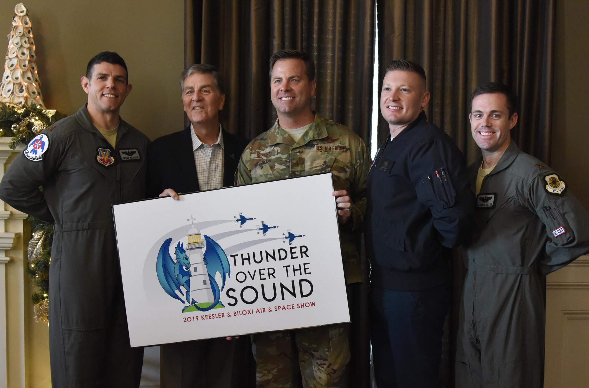 Keesler and Biloxi leadership, along with two U.S. Air Force Thunderbird pilots, pose for a photo during a press conference formally announcing Thunder Over the Sound: The Keesler and Biloxi Air and Space Show at the Biloxi Visitors Center, in Biloxi, Mississippi, Dec. 18, 2018. The press conference reviewed and confirmed information and acts for the air show and allowed attendees to meet with and ask questions of all speakers. (U.S. Air Force photo by Kemberly Groue)