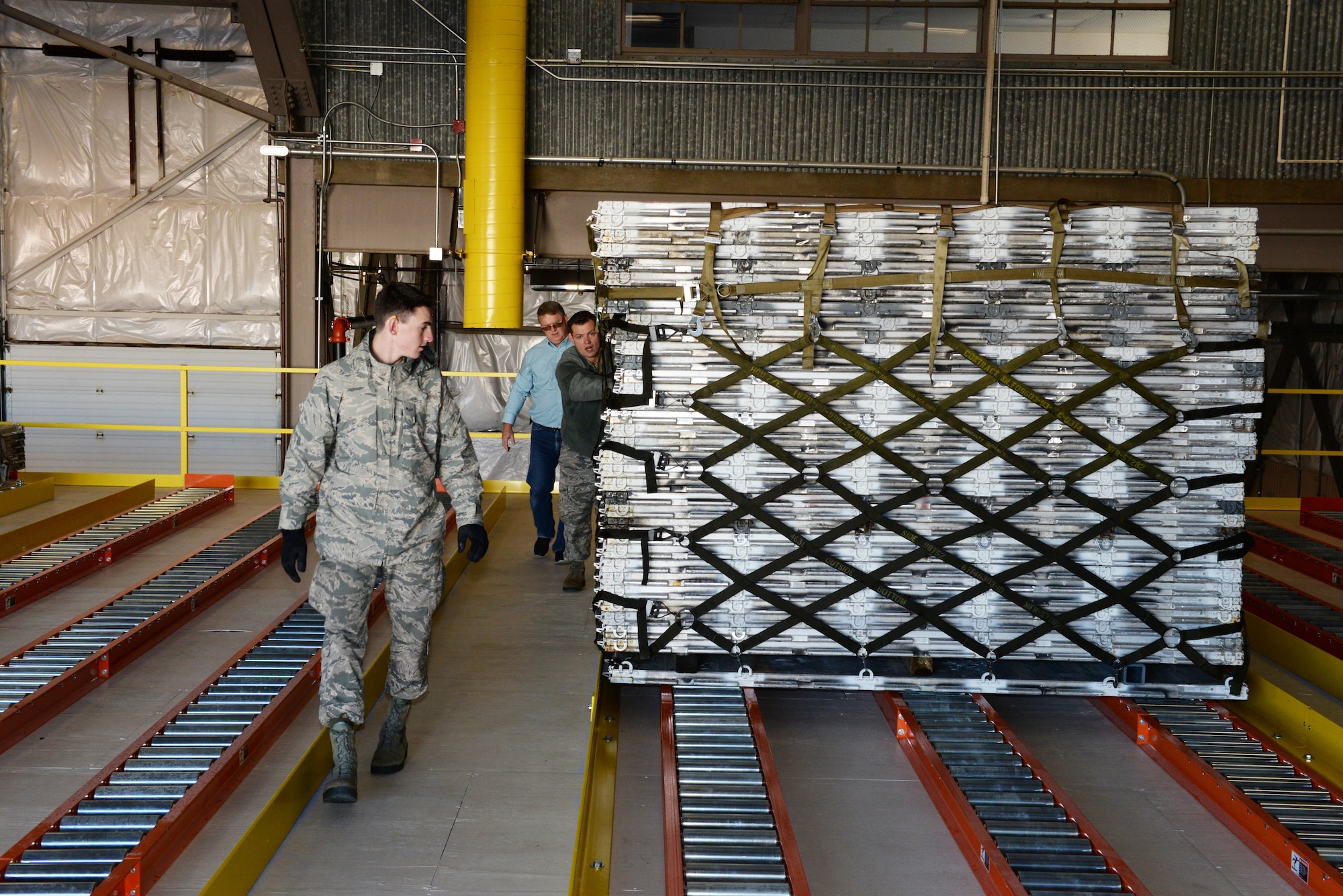 Airman 1st Class Hugh McMackin and Staff Sgt. Ryan Olszewski guide a pallet on the new pallet racking system, Nov. 7, 2018, at Pease Air National Guard Base, N.H. (Photo by Master Sgt. Thomas Johnson, 157th ARW Public Affairs)