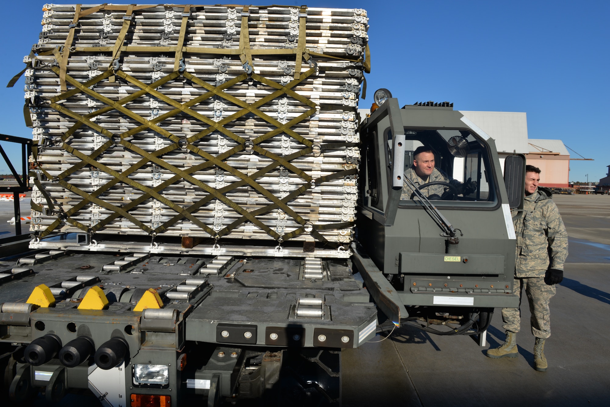 Senior Airman Andrew Poole and Airman 1st Class Hugh McMackin prepare to load a pallet onto the new pallet racking system using a Halvorsen 25K loader, Nov. 7, 2018, at Pease Air National Guard Base, N.H.(Photo by Master Sgt. Thomas Johnson, 157th ARW Public Affairs)