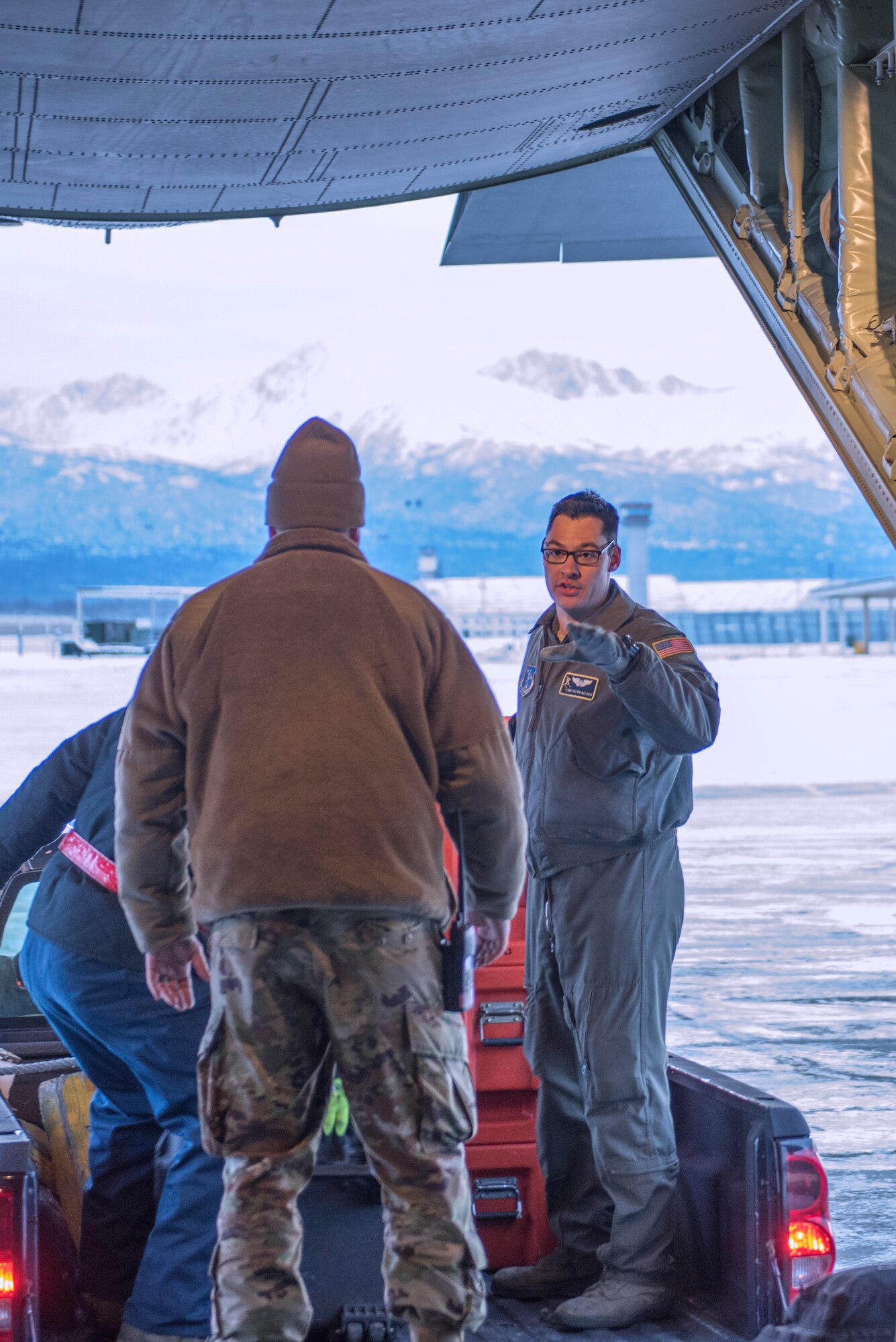 Senior Airman Dalton Galindo, a loadmaster with the 211th Rescue Squadron, directs cargo movement on a C-130J “Combat King II” at Joint Base Elmendorf-Richardson, Alaska, Nov. 30, 2018. In a matter of hours, members of the Alaska Air National Guard's Maintenance and Operation groups turned a planned community engagement into an aerial survey of earthquake damage in Southcentral Alaska, reporting findings to the State of Alaska's Joint Operations Center.