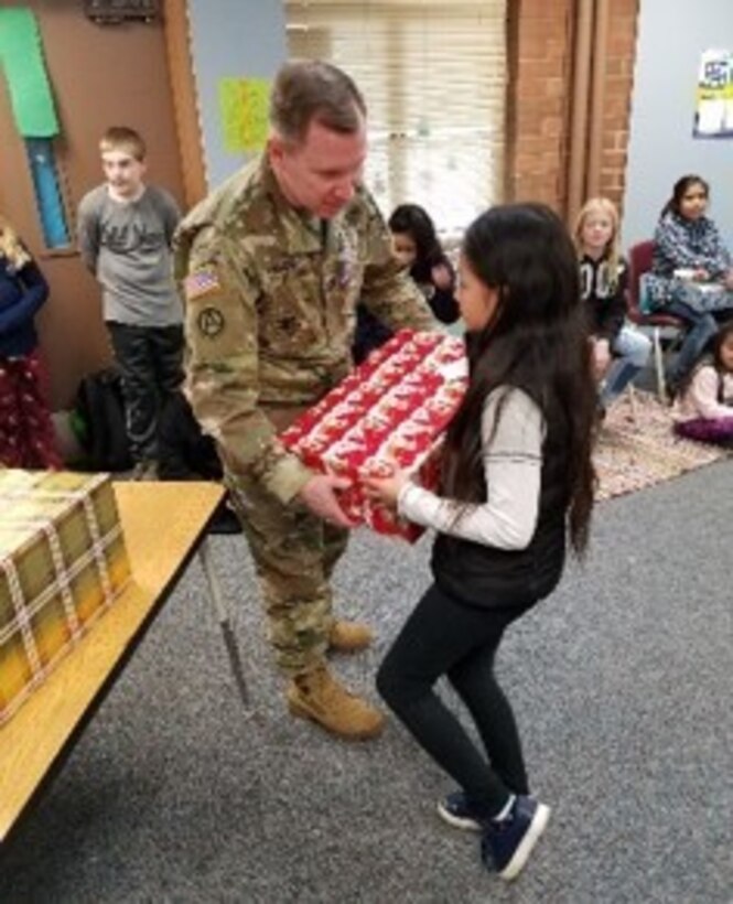 U.S. Army Reserve’s 364th Sustainment Command (Expeditionary) helped brightened the holidays of 25 local students attending Shoultes Elementary with  presentation of Christmas gifts this week as part of its 2nd annual Operation Giving Tree. For the past few weeks, ‘Sustain the Fight’ Soldiers and civilian employees collected donated items requested by the children and delivered them to the school before winter b+eak. Shoultes Elementary is part of the 364th ESC’s School Partnership Program.