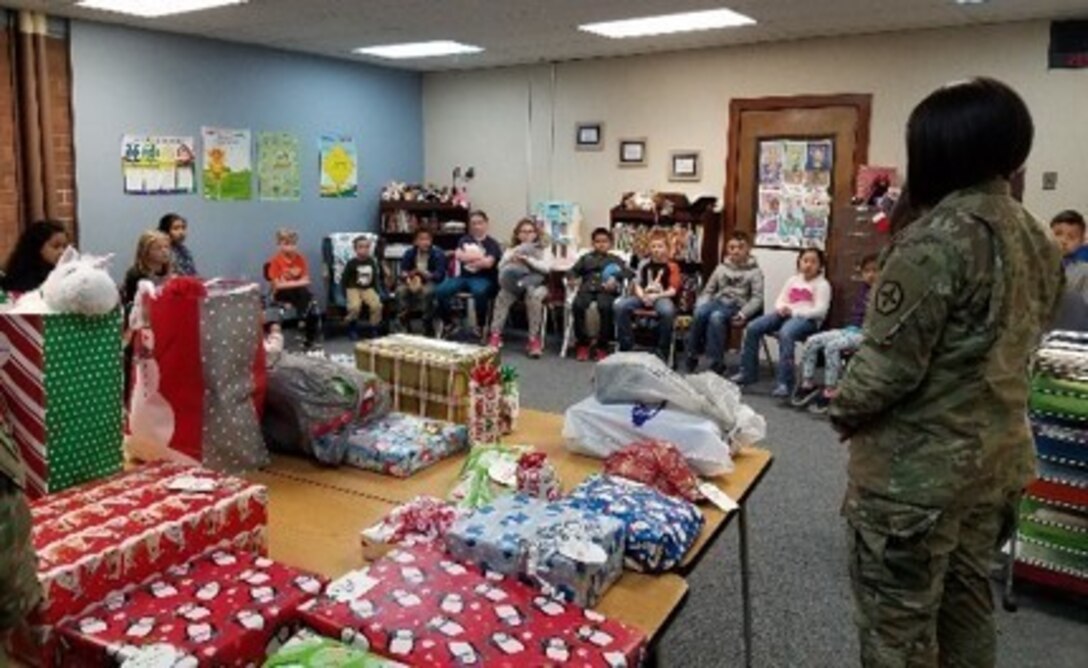 U.S. Army Reserve’s 364th Sustainment Command (Expeditionary) helped brightened the holidays of 25 local students attending Shoultes Elementary with  presentation of Christmas gifts this week as part of its 2nd annual Operation Giving Tree. For the past few weeks, ‘Sustain the Fight’ Soldiers and civilian employees collected donated items requested by the children and delivered them to the school before winter b+eak. Shoultes Elementary is part of the 364th ESC’s School Partnership Program.