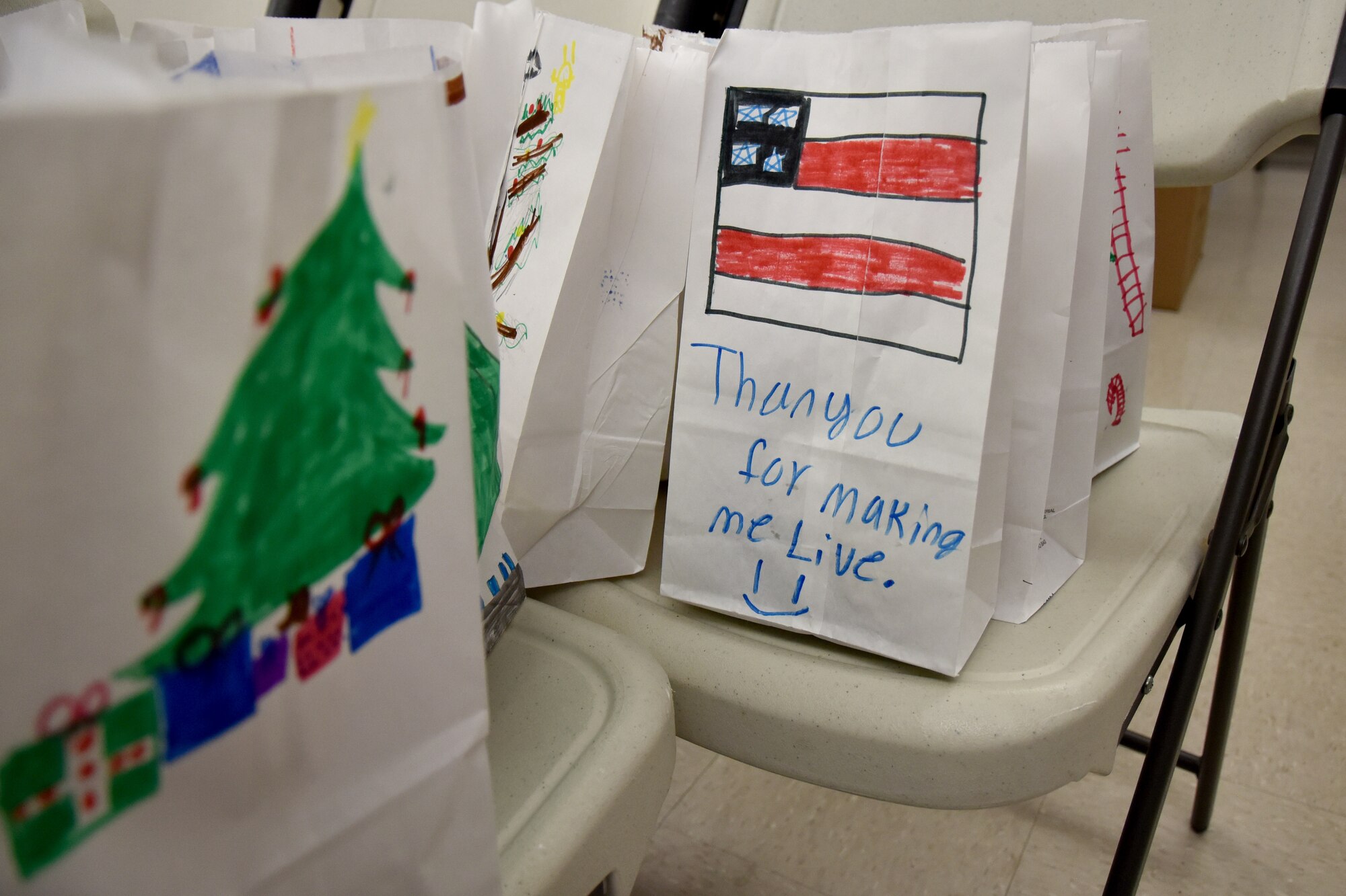 Children from a local school decorated the bags the cookies were placed in with festive artwork. They thanked service members and wished them a Merry Christmas. (U.S. Air Force photo by 2nd Lt. Matthew Stott/Released)