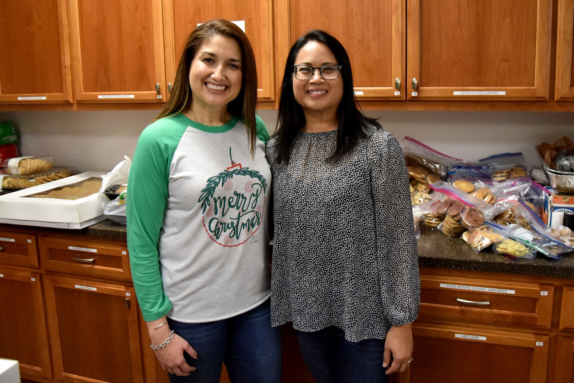 Jeannette Ramirez, a volunteer, stands next to Darlene Salomon, the event coordinator. Both women played a role in the organization and success of the Cookie Caper this year. (U.S. Air Force photo by 2nd Lt. Matthew Stott/Released)