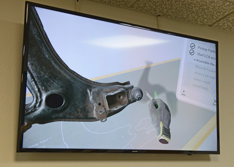 The screen shows what a person wearing a virtual reality headset is doing in this maintenance training program demonstrated by aircraft maintainers Dec. 20. (U.S. Air Force photo by Kenji Thuloweit)