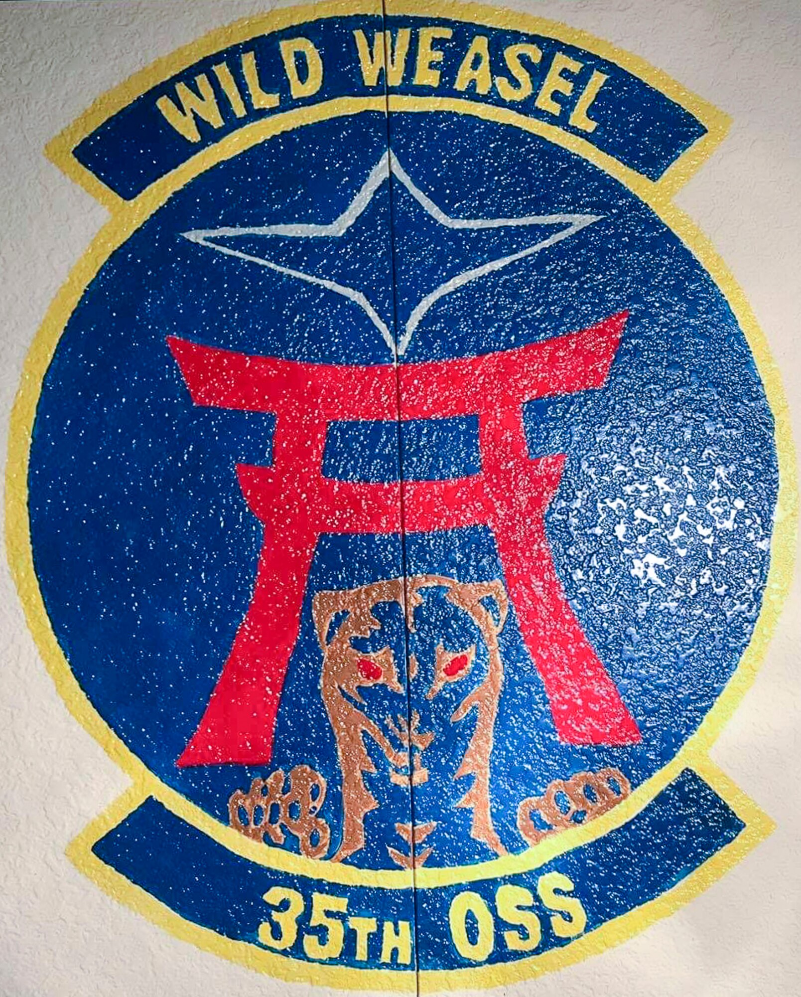 Sharon Smith, the wife of Maj. Brian Smith, a physical therapist with the 35th Medical Operations Squadron, painted the 35th Operations Support Squadron mural at Misawa Air Base, Japan, in 2017. The commander requested her artistic skills to remake the squadron patch into a mural as a way to help create identity and morale in the unit. (Courtesy photo by Sharon Smith)