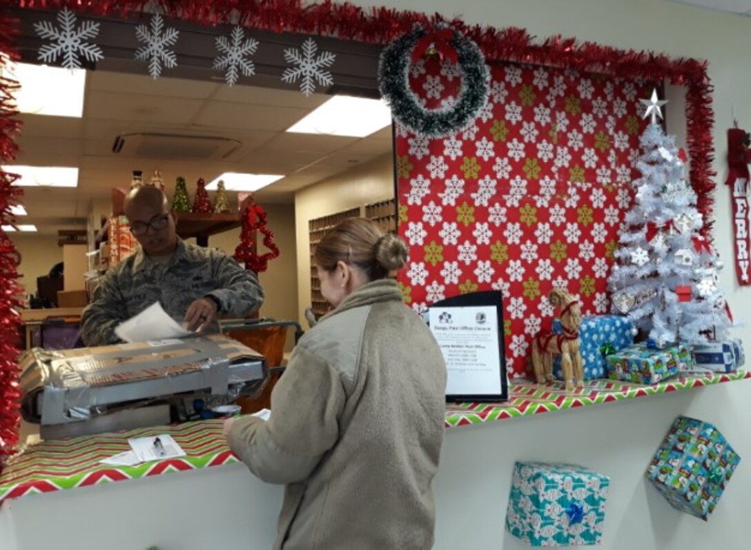 U.S. Air Force Staff Sgt. McGarrette Dela Cruz, administration management technician, processes outgoing mail as the postmaster of the 607th Material Maintenance Squadron at Daegu Air Base, Republic of Korea, Dec. 14, 2018. Dela Cruz processes hundreds of incoming and outgoing mail, especially during the holiday season, as the sole postmaster serving the 607th MMS. (Courtesy photo by U.S. Air Force Tech. Sgt. James Frye)