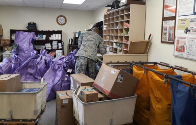 U.S. Air Force Staff Sgt. McGarrette Dela Cruz, administration management technician, sorts through incoming mail as the postmaster of the 607th Material Maintenance Squadron at Daegu Air Base, Republic of Korea, Dec. 14, 2018. Dela Cruz travels to multiple bases throughout the week in support of the 607th MMS, in a one-person deep position. (Courtesy photo by U.S. Air Force Tech. Sgt. James Frye)