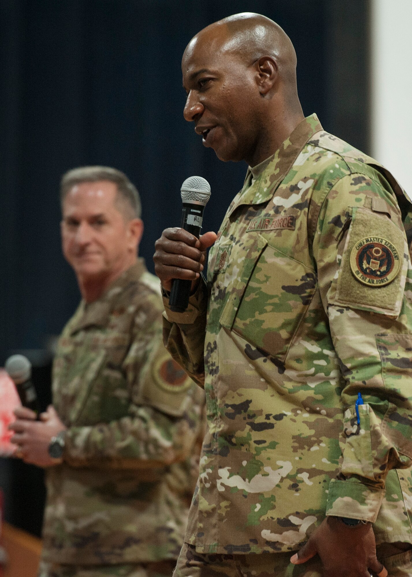 Chief Master Sgt. of the Air Force Kaleth O. Wright and Air Force Chief of Staff Gen. David L. Goldfein answer questions from Airmen during a base-wide “all call” at Al Udeid Air Base, Qatar, Dec. 19, 2018. Wright mentioned potential future changes to the physical training uniform, among other efforts to continuously improve how Airmen train and fight.  (U.S. Air Force photo by Tech. Sgt. Christopher Hubenthal)