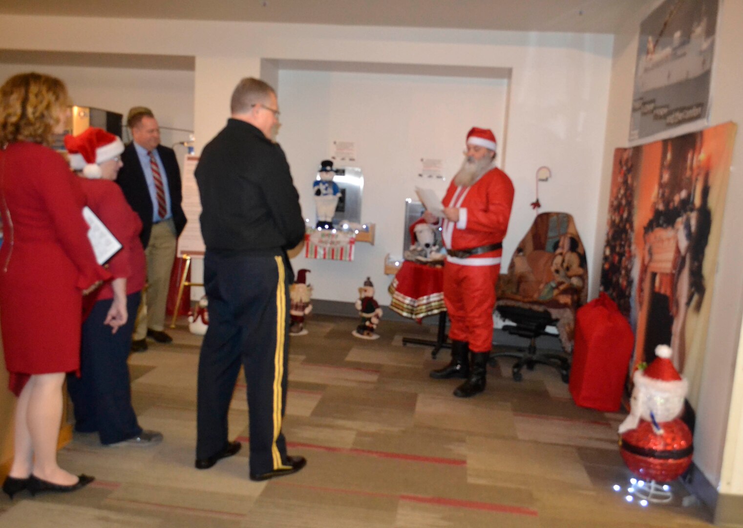 Defense Logistics Agency Troop Support leaders gather as they enjoy a reading from Santa as part of the Medical supply chain’s entry in the 2018 holiday decorating contest in Philadelphia Dec. 20, 2018.