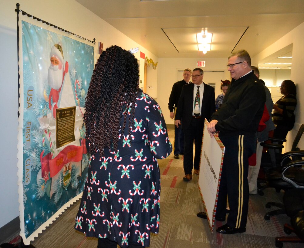 Defense Logistics Agency Troop Support leaders gather as the Procurement Office presents their entry in the 2018 holiday decorating contest in Philadelphia Dec. 20, 2018.
