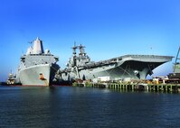 USS Kearsarge (LHD 3) and USS Arlington (LPD 24) in port gearing up for deployment