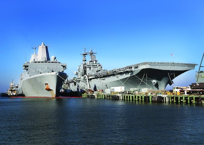 USS Kearsarge (LHD 3) and USS Arlington (LPD 24) in port gearing up for deployment