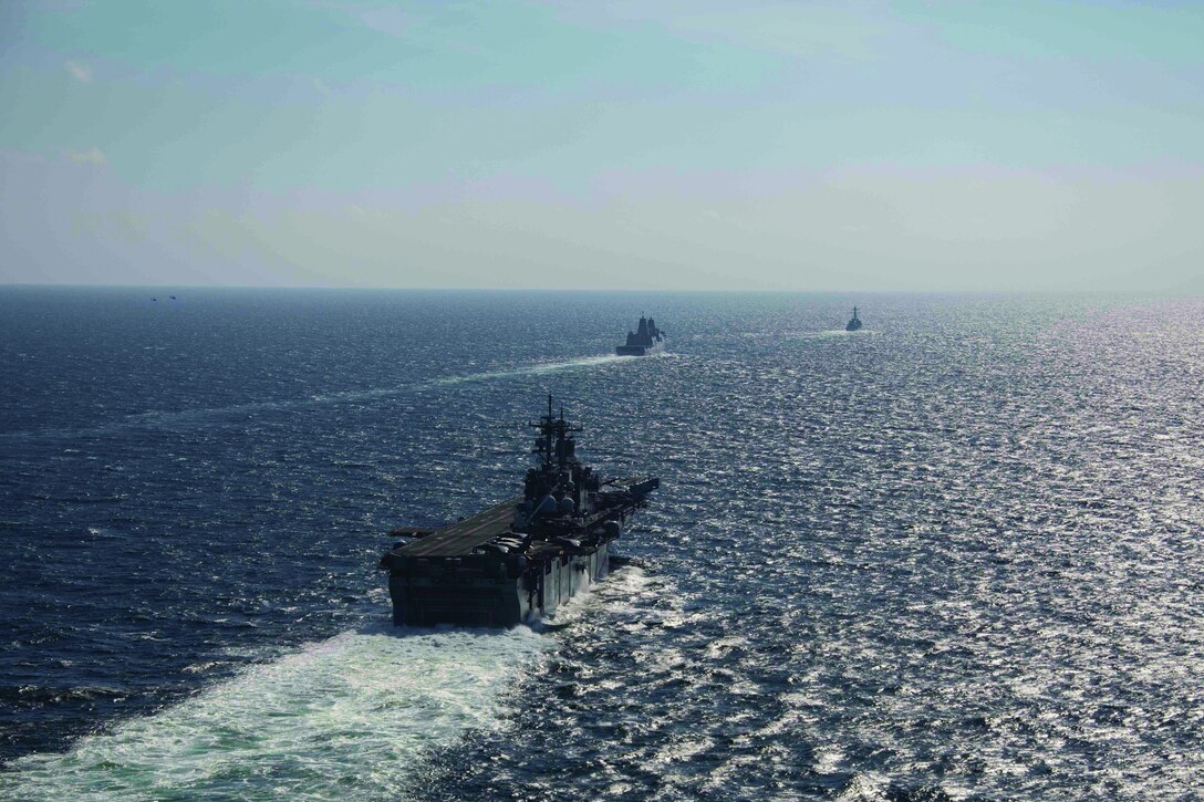 USS Kearsarge (LHD 3) and USS Arlington (LPD 24) in port gearing up for deployment
