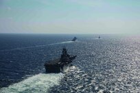 USS Kearsarge (LHD 3) and USS Arlington (LPD 24) in port gearing up for deployment