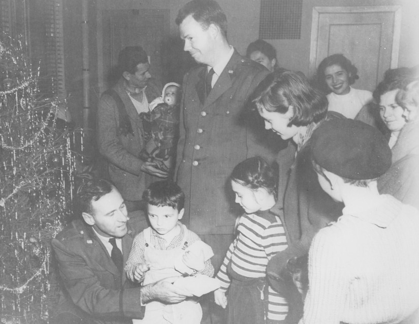 Hungarian refugee children receive Christmas gifts from military and civilian members of Charleston Air Force Base, S.C., in December of 1956.