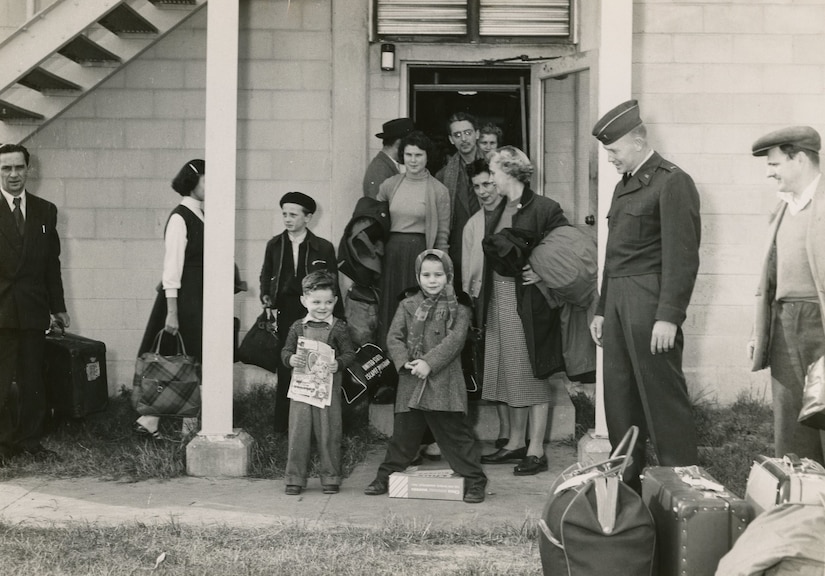 Hungarian refugees wait outside building 246 at Charleston Air Force Base, S.C., in December of 1956.