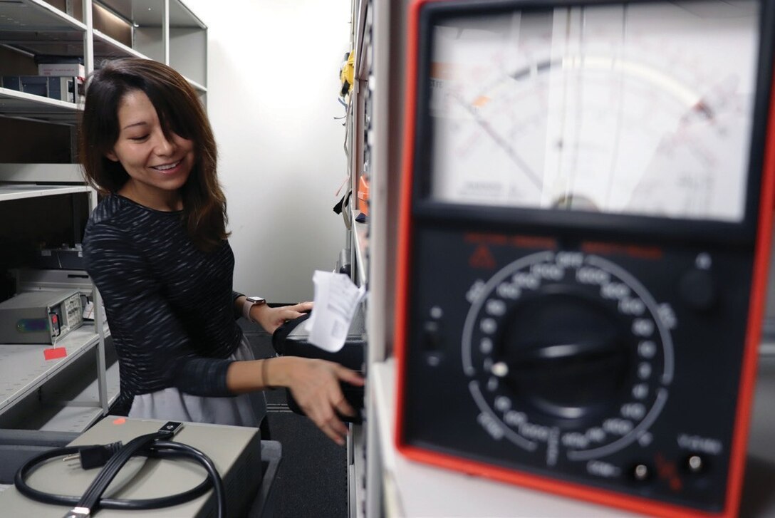 Employee testing electronic equipment