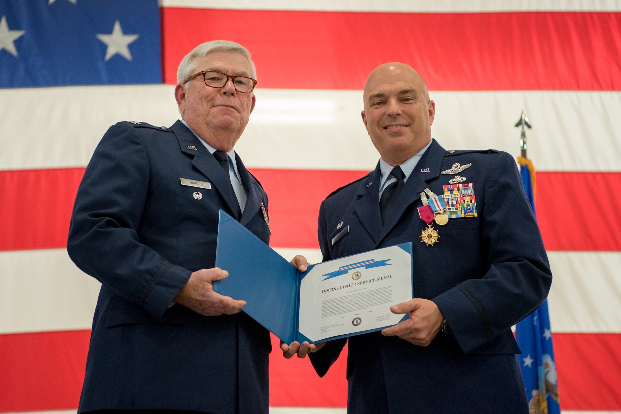 Col. Ken Dale (right), outgoing commander of the 123rd Maintenance Group, receives the Distinguished Service Medal from retired Col. Michael Harden, former commander of the 123rd Airlift Wing, during Dale’s retirement ceremony at the Kentucky Air National Guard Base in Louisville, Ky., on Dec. 1, 2018. Dale is retiring after more than 38 years of service to the Kentucky Air National Guard. (U.S. Air National Guard photo by Staff Sgt. Joshua Horton)