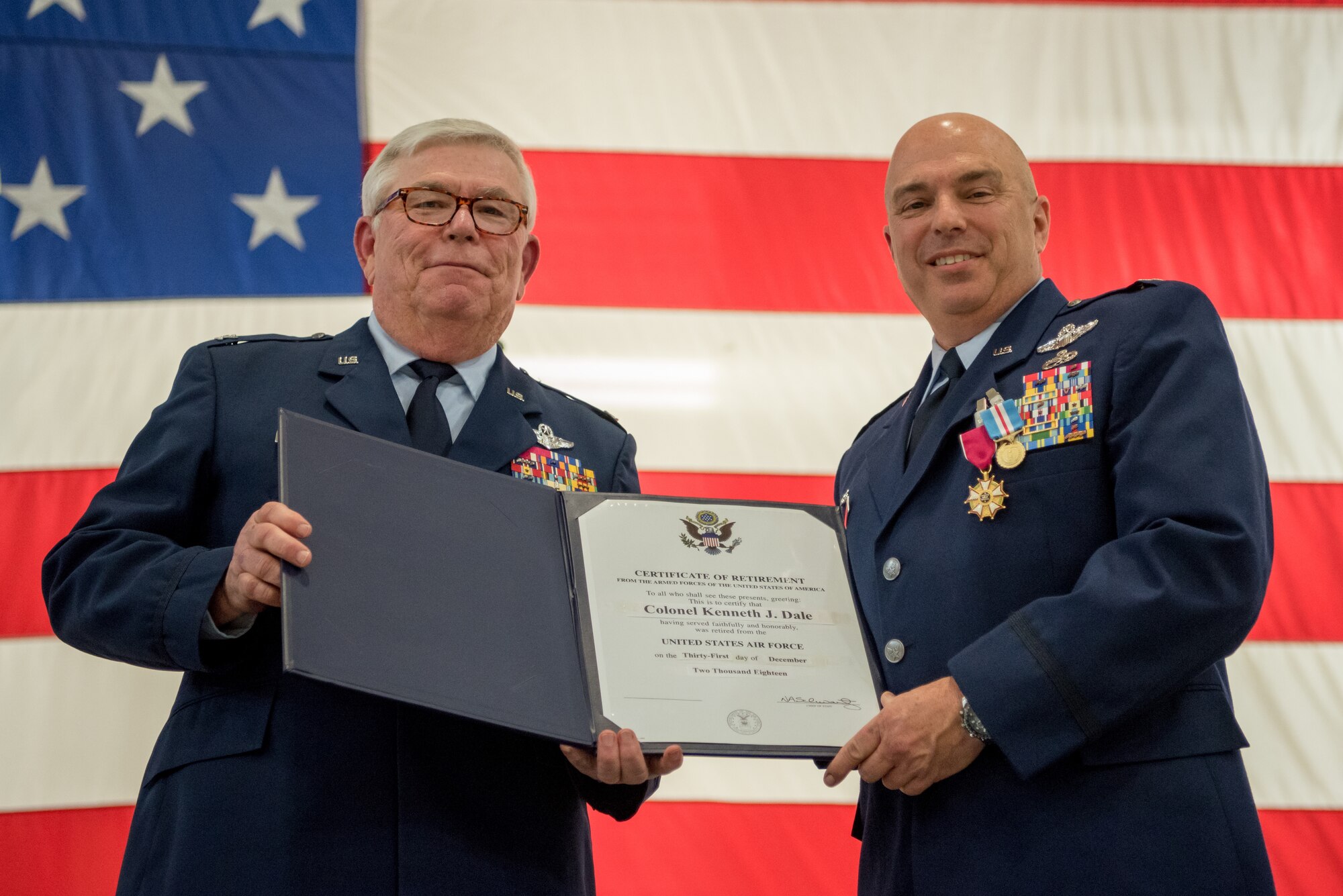 Col. Ken Dale (right), outgoing commander of the 123rd Maintenance Group, receives a certificate of retirement from retired Col. Michael Harden, former commander of the 123rd Airlift Wing, during Dale’s retirement ceremony at the Kentucky Air National Guard Base in Louisville, Ky., on Dec. 1, 2018. Dale is retiring after more than 38 years of service to the Kentucky Air National Guard. (U.S. Air National Guard photo by Staff Sgt. Joshua Horton)