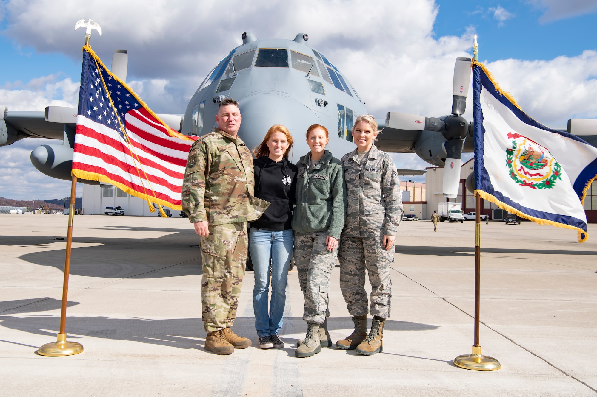 Lt. Col. Andrew Farmer, 130th Logistics Readiness Squadron Commander, stands with his daughters Halle Farmer, Staff Sgt. Alexis Farmer and Senior Airman Carly Farmer in front of a C-130H Nov. 3, 2018 at McLaughlin Air National Guard Base, Charleston, W.Va. (U.S. Air National Guard Photo by Airman 1st Class Caleb Vance)