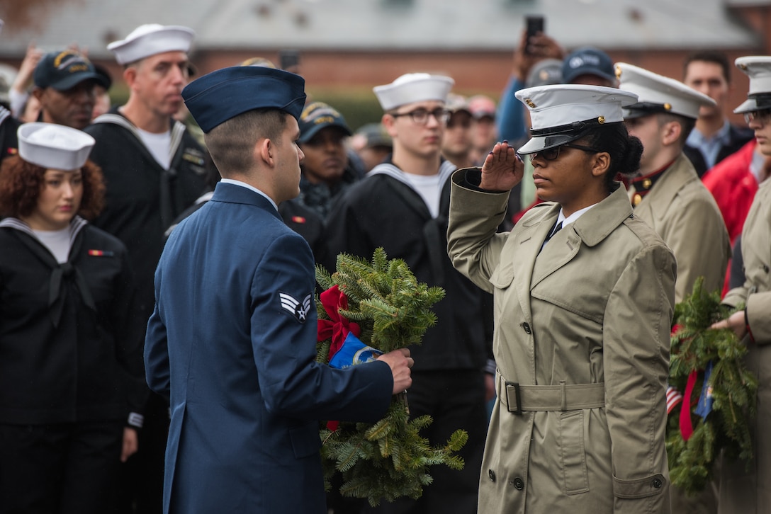 A U.S. Marine Corp Marine salutes after handing the dedicated U.S. Air Force wreath to a U.S. Air Force Airman in honor of National Wreaths Across America Day at Hampton National Cemetery in Hampton, Virginia, Dec. 15, 2018.