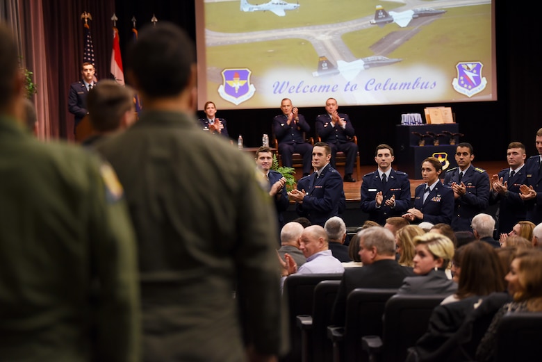 Specialized Undergraduate Pilot Training students stand and clap to recognize instructor pilots during their graduation Dec. 14, 2018, on Columbus Air Force Base, Mississippi. Maj. Gen. Scott Pleus, director of plans, programs, and requirements at Air Combat Command Headquarters at Joint Base Langley-Eustis, Virginia, was the guest speaker for SUPT Class 19-03. (U.S. Air Force photo by Airman 1st Class Keith Holcomb)