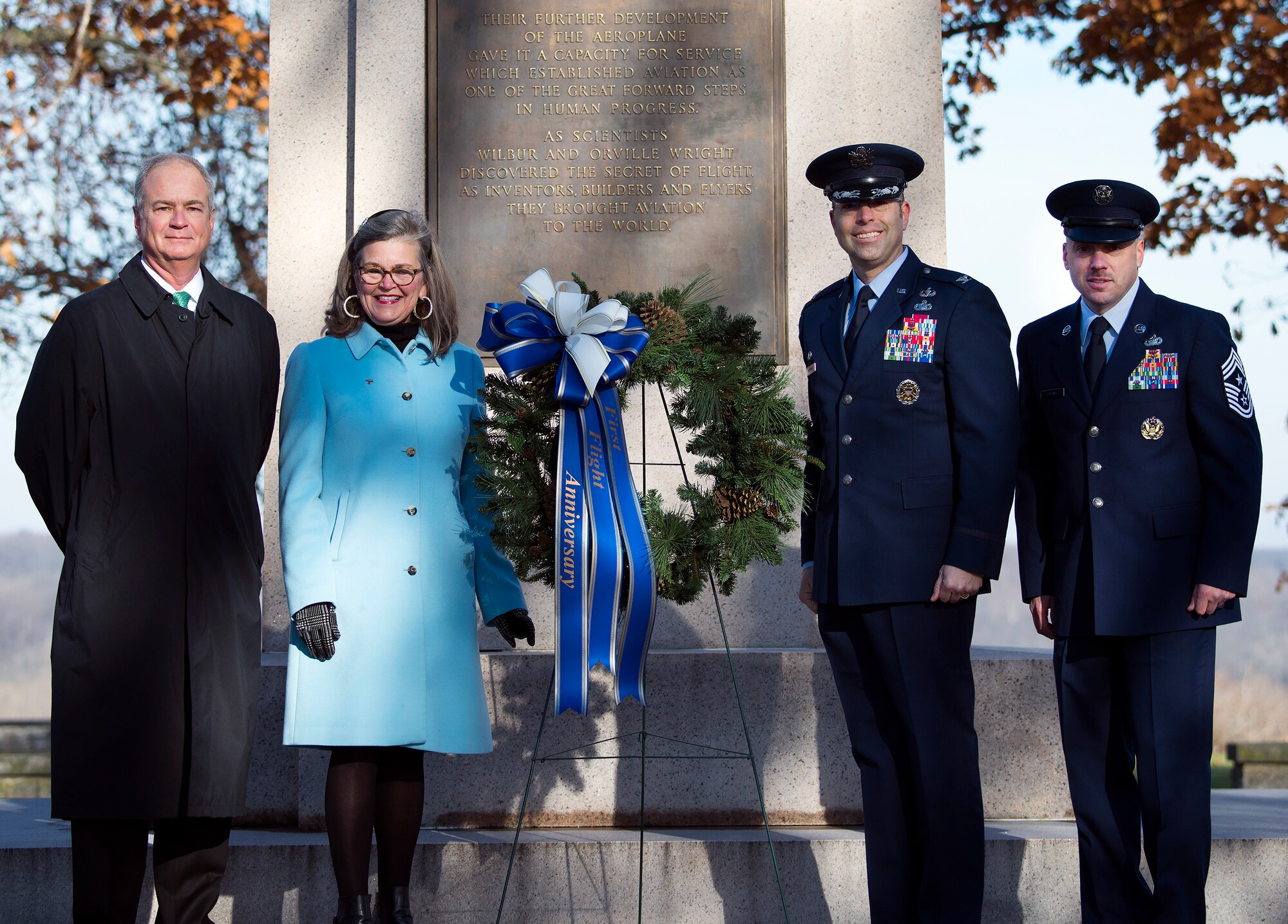 Wright family members Stephen Wright and Amanda Wright Lane join Col. Thomas P. Sherman, 88th Air Base Wing and installation commander, and Chief Master Sgt. Stephen A. Arbona, 88th ABW command chief, in laying a wreath at the Wright Brothers Memorial on Wright-Patterson Air Force  Base, Ohio, Dec. 17, 2018.
